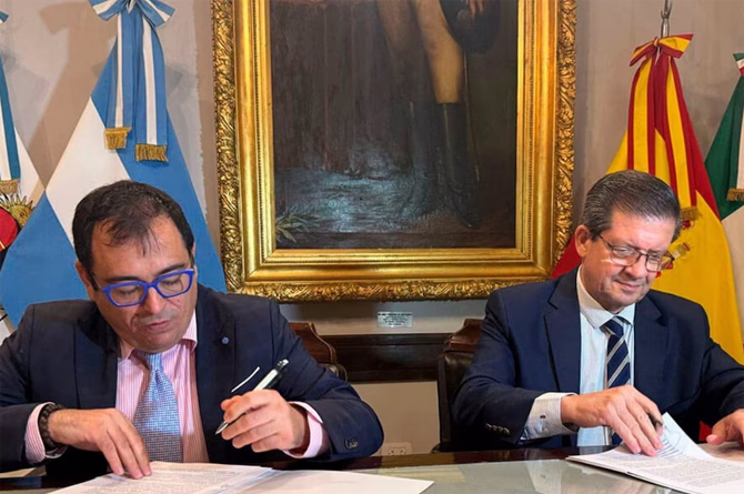 José Hernández, izquierda, firma el convenio con Néstor Pedro Braillard Poccard, vicegobernador de Corrientes